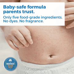 Baby's belly with a hand touching it, featuring Waxhead Healing Salve and text about baby-safe formula.