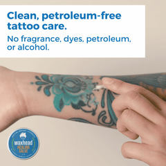 Person applying waxhead salve to a tattoo with text about clean, petroleum-free tattoo care.