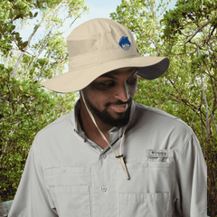 Man wearing tan Columbia Booney Hat for sun protection while hiking outdoors