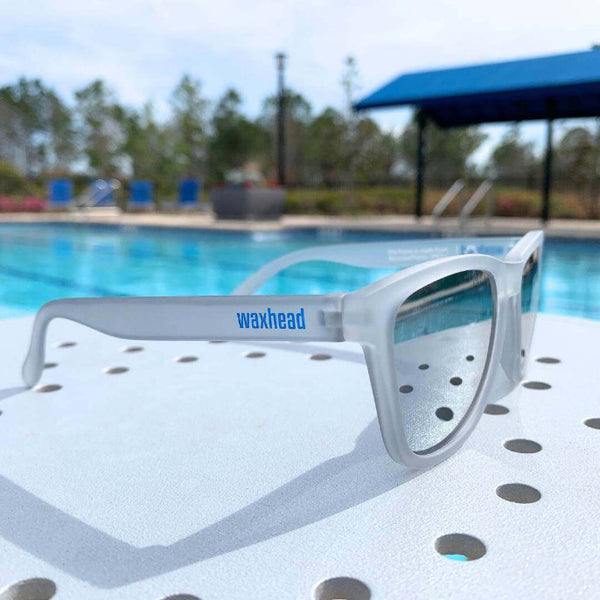 Silver Polarized Sunglasses by Waxhead, placed near a poolside, showcasing stylish design and UV protection.