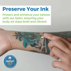 Healing Salve Shea Butter Balm applied to tattooed arm for preserving ink and enhancing body art.