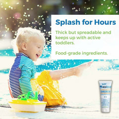 A joyful toddler splashing in water, using Baby Mineral Sunscreen Zinc Oxide for gentle protection with food-grade ingredients.