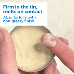 Healing Salve Shea Butter Balm shown in tin with a finger applying the balm, demonstrating its smooth texture.