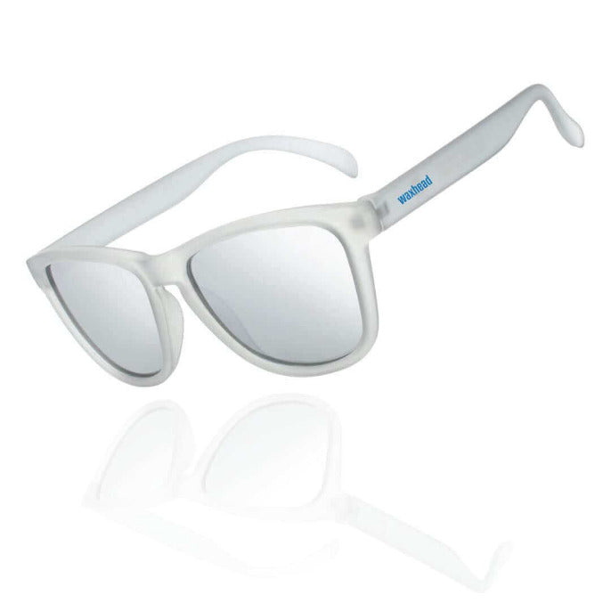 Silver Polarized Sunglasses – Recycled Plastic / TARPON with sleek mirrored lenses on a reflective surface.