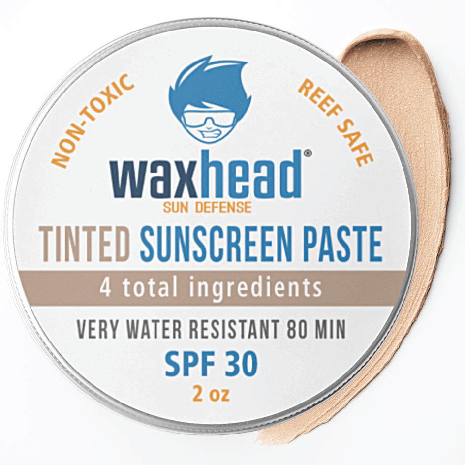 Reef-Safe Tinted Zinc Sunscreen Paste for Face by Waxhead in a tin with a red bow, non-toxic, SPF 30, very water resistant.